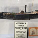 A detailed model of Cushing's Steam Picket Boat, displayed in a museum case.