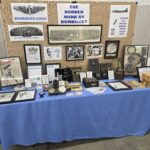 A museum display featuring various artifacts and information about World War II bombing technology, including the Norden Bombsight, B-17 instrument panel, and related devices.