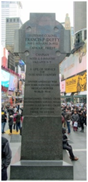 A large stone Celtic cross monument with inscriptions detailing the service of Lieutenant Colonel Francis P. Duffy.